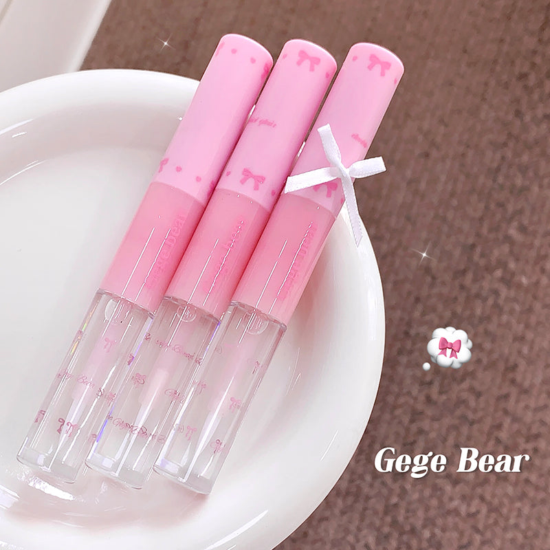 Three pink lip glosses with clear tubes on a white plate, branded 'Gege Bear'.