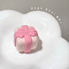 Pink and white bear-shaped container with a bow on a white background, featuring the brand 'Gege bear'.