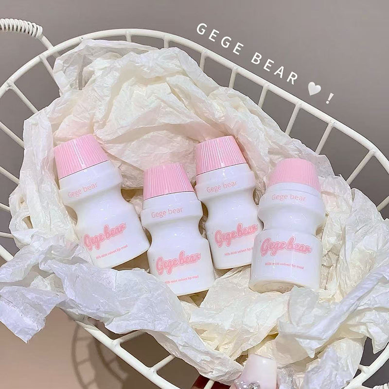 Set of small white bottles with pink caps on a white mesh bag, branded 'Gegebear'.