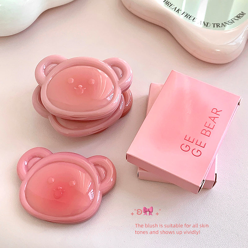 Pink bear-shaped blush with packaging on a light background