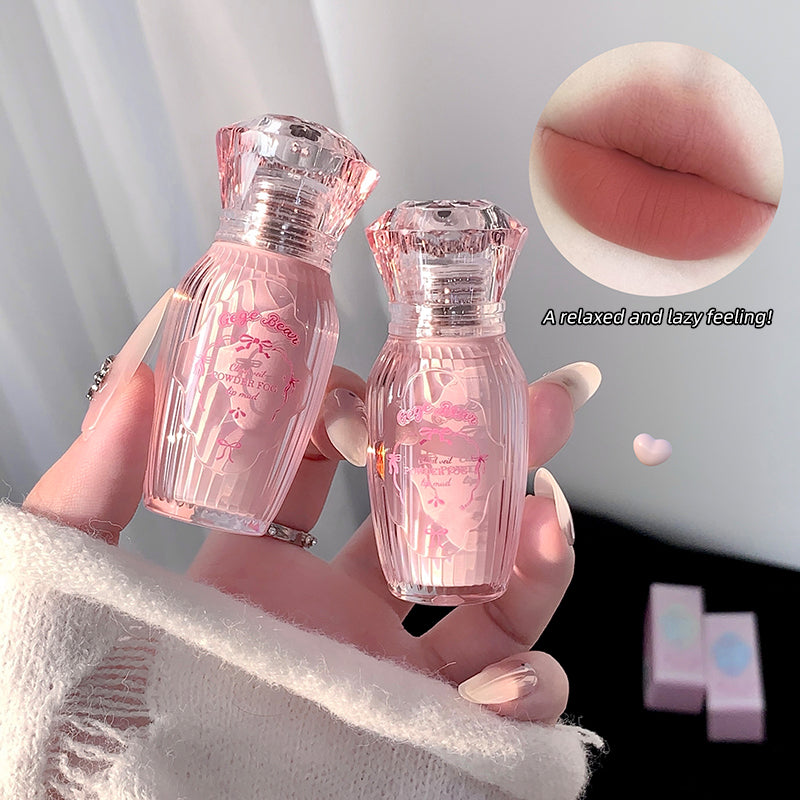 Two small pink bottles held by a hand with a close-up of lips and text on a light gray background.