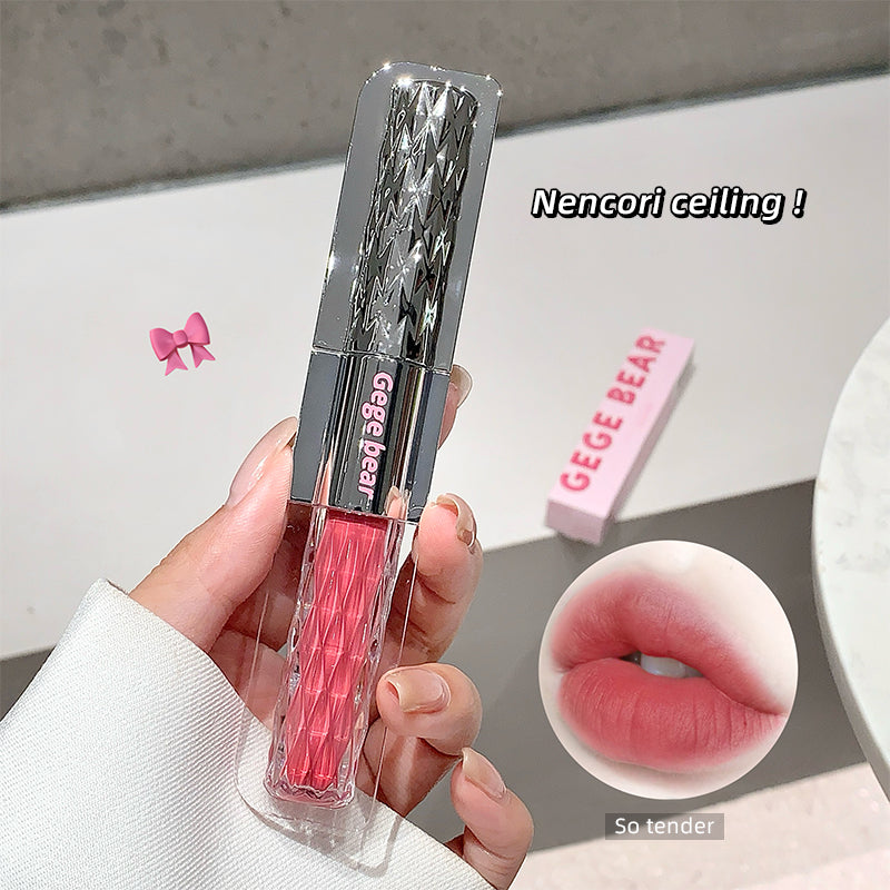 Lip gloss with decorative packaging held by a hand, GEGE BEAR brand visible