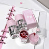 Pink and silver GEGER BEAR products including a water bottle, lip balm, and stationery items on a white surface.