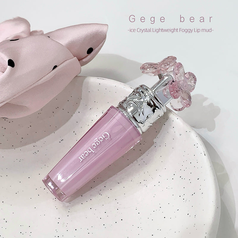 Pink lip gloss with floral design on cap on a white background, featuring 'Gege bear' branding.