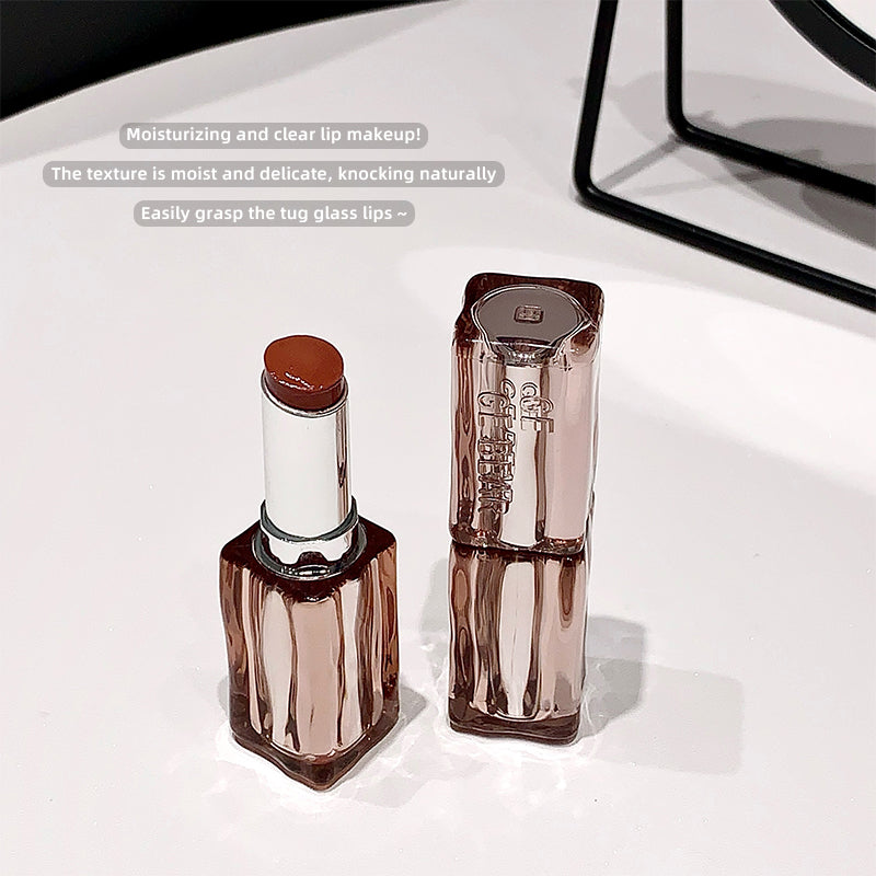 Two lip products on a white surface with text about moisturizing and clear lip makeup.