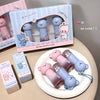 Cute bear-themed lip mats with packaging on a beige surface