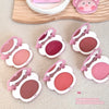 Set of pink makeup compacts on a textured surface
