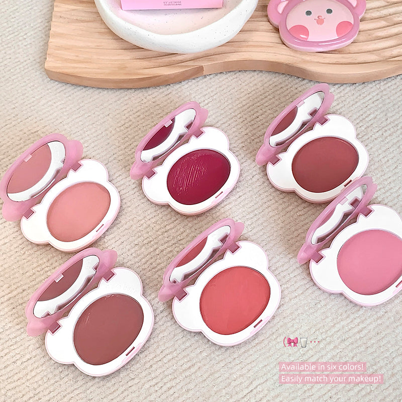 Set of pink makeup compacts on a textured surface