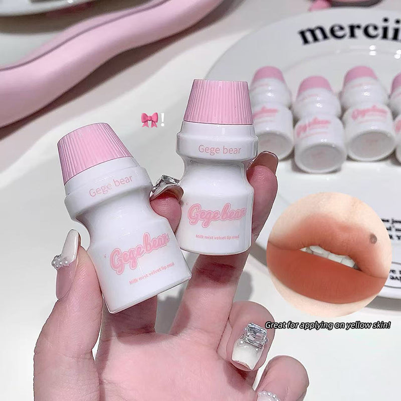 Small white bottles with pink caps labeled 'Geege bear' held by a hand.