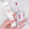 Pink lip gloss with bunny design held by a hand on a light gray background