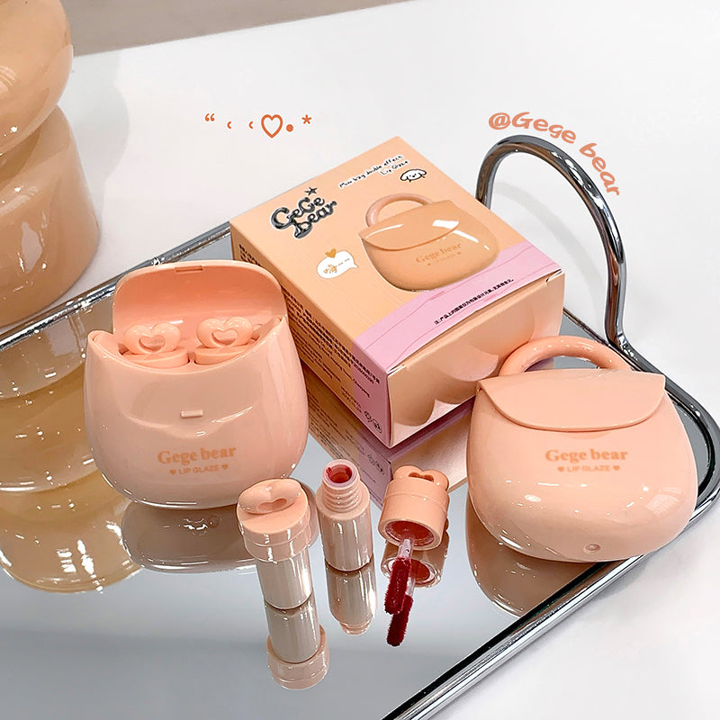 Pink cosmetic set with 'Gege bear' branding on a reflective surface.