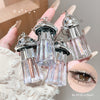 Silver cosmetic bottles with glittery contents held by a hand, with an inset of a eye wearing the product.