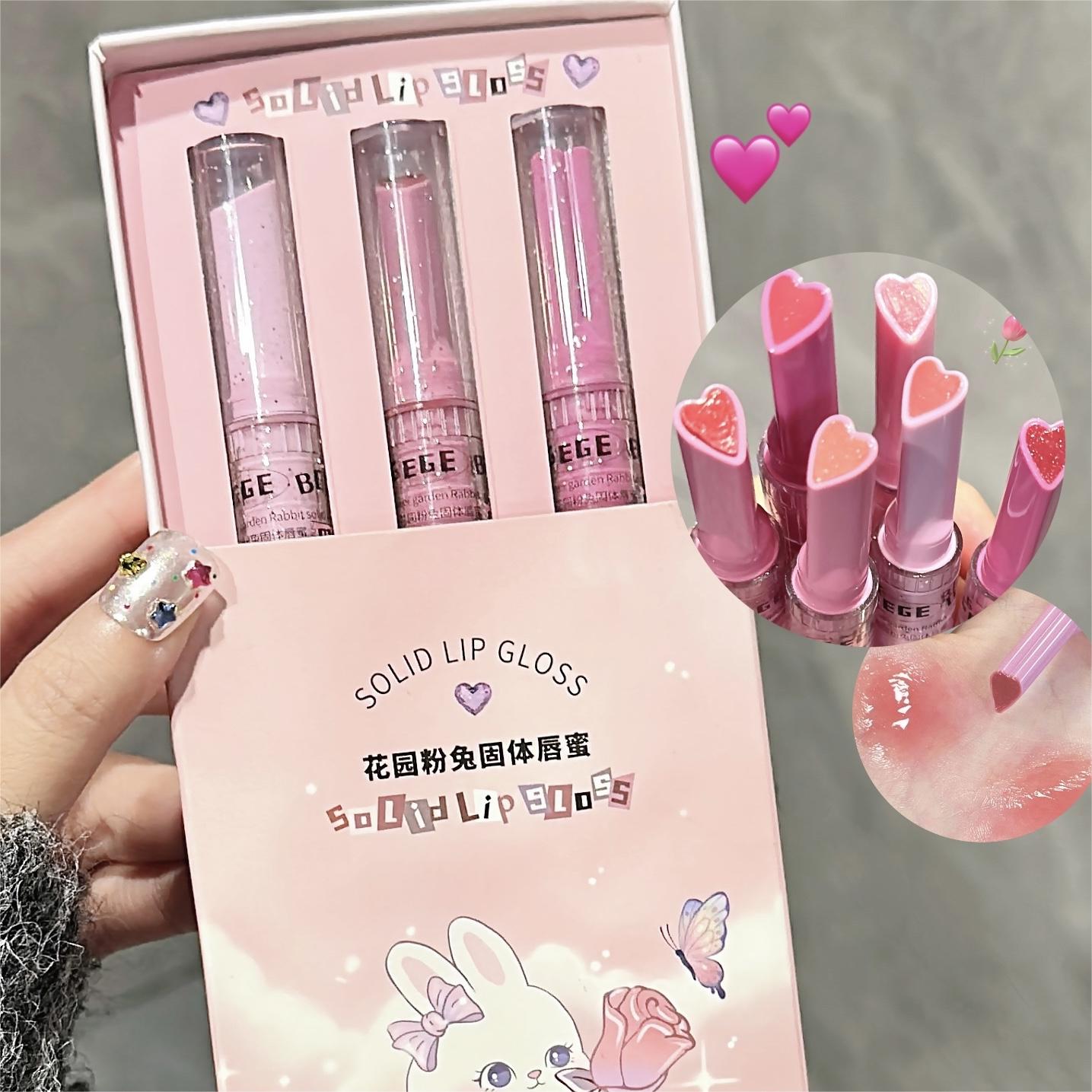 Set of solid lip glosses in a pink box with cartoon character, hearts, and 'SOLID LIP GLOSS' text.