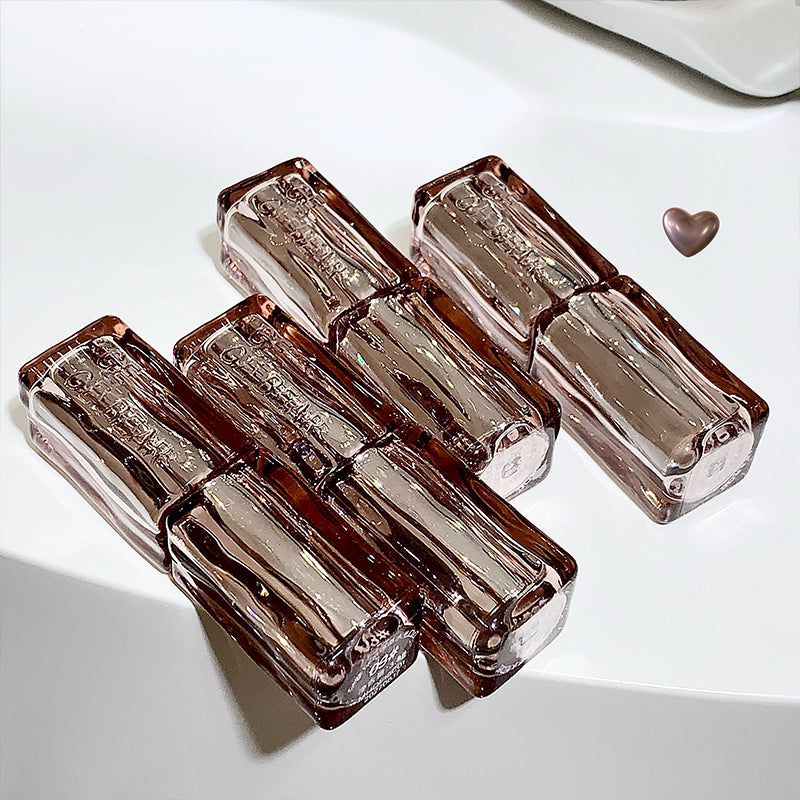 Set of four transparent brown glass containers on a white surface