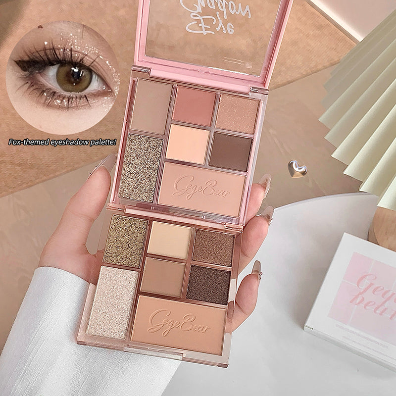 Makeup palette with 'GigiBella' branding held by a hand, close-up of eye with glittery makeup.