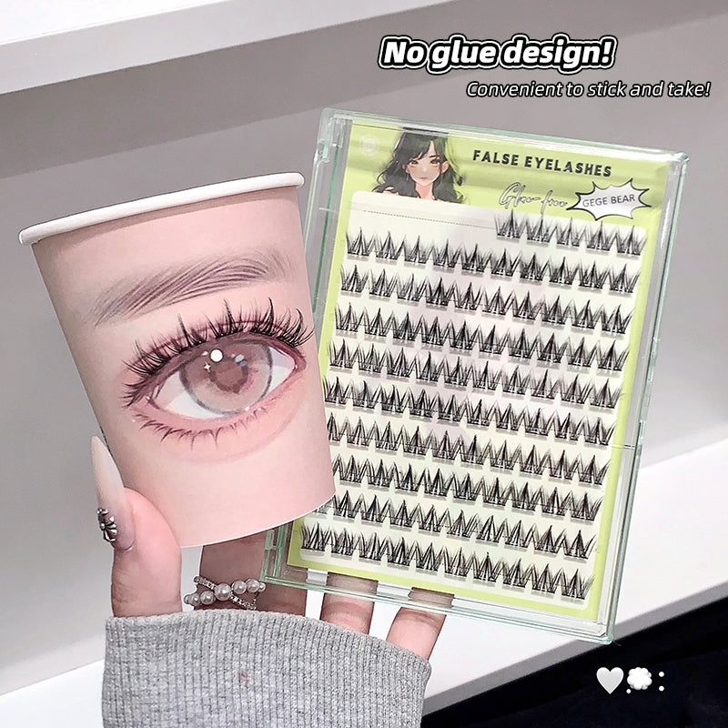 False eyelashes packaging with a close-up of an eye wearing false eyelashes, held by a hand.