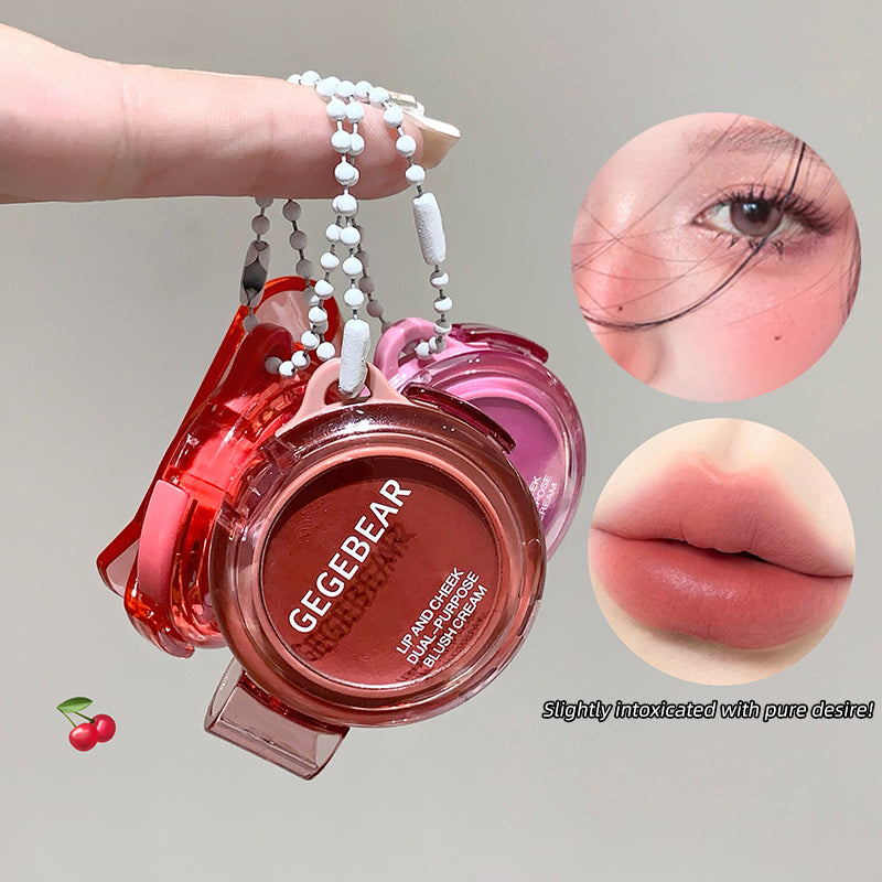 Lip product with 'GEGEBEAR' branding, close-up of eye and lips, and cherry icon.