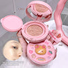 Pink cosmetic compact with mirror, air cushion, and puff, featuring a bear design.