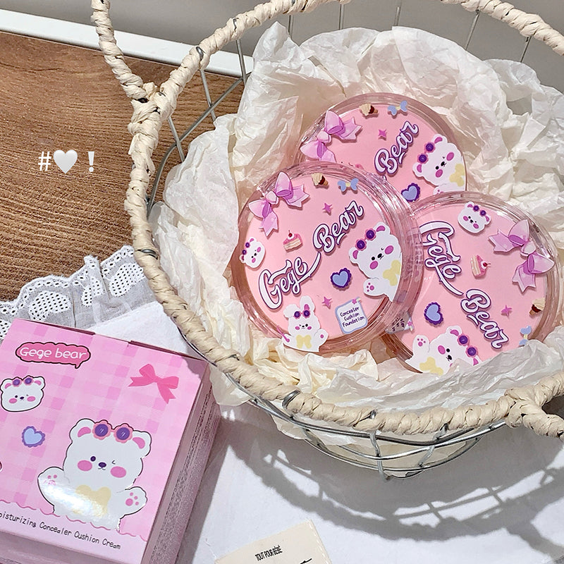 Pink cushion compact with 'Cute Bear' branding in a wicker basket on a light surface.