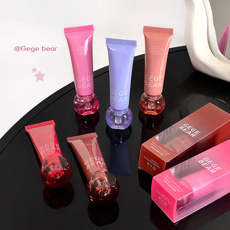 Set of Gege Bear lip balm tubes and packaging on a black surface