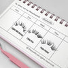 Calendar with false eyelash illustrations and a pink pair of tweezers on a light gray background