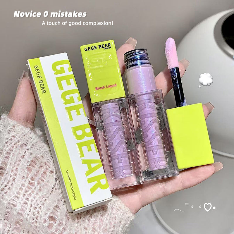 Lip gloss with packaging and brush held in a hand, labeled 'GEGE BEAR'.