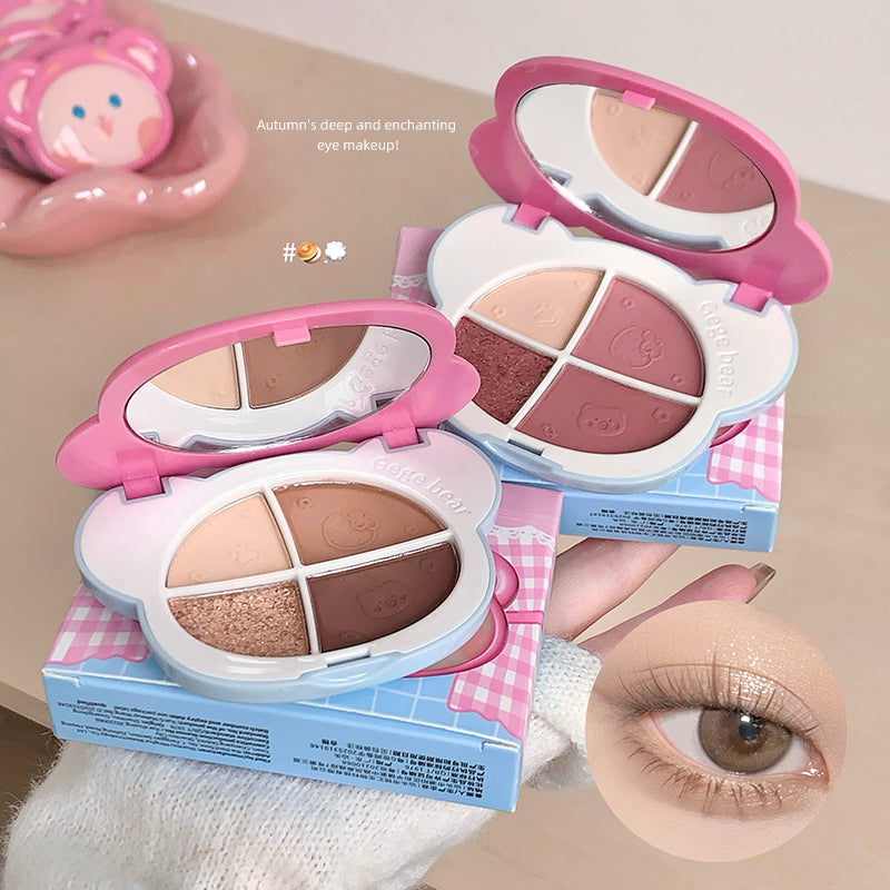 Makeup palette with pink and white design, open to show color swatches, on a beige background.