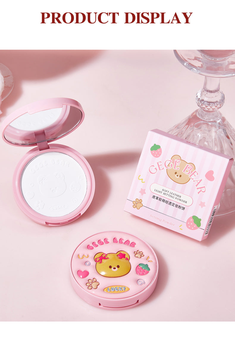 Pink compact powder with a bear design and packaging on a pink background