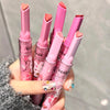 Five pink lip balms with cartoon designs held by a hand against a neutral background