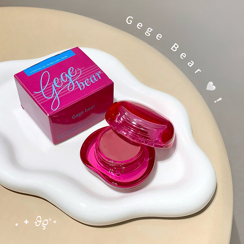 Pink compact mirror with open lid and Gege Bear packaging on a white surface.