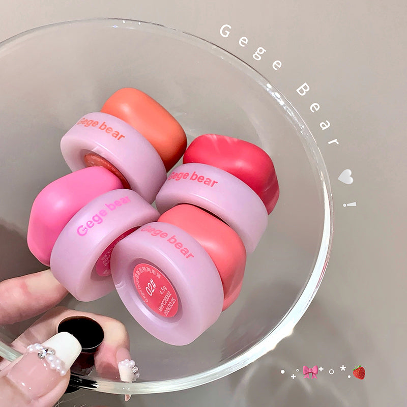 Pink and orange baby rattle with 'Gege Bear' branding on a clear surface.