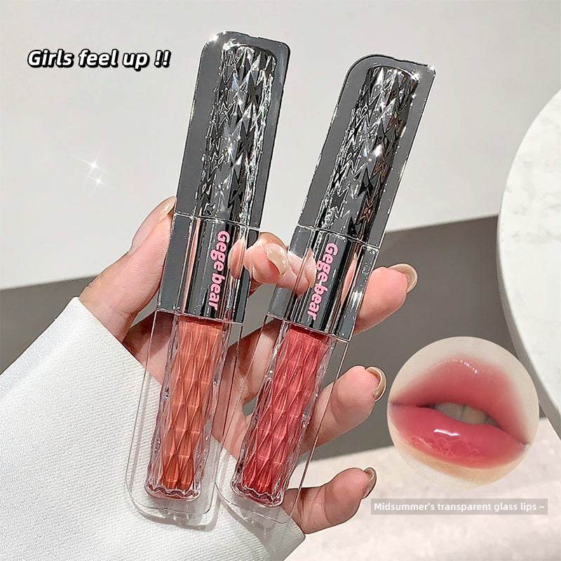 Two lip glosses in packaging held by a hand, with a close-up of a mouth wearing the product.