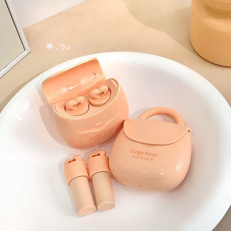 Pink wireless earbuds with charging case on a white surface