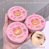 Three pink compact mirrors with bear design held by a hand, with text about base makeup.