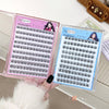 False eyelashes in a pink and blue case on a wooden surface