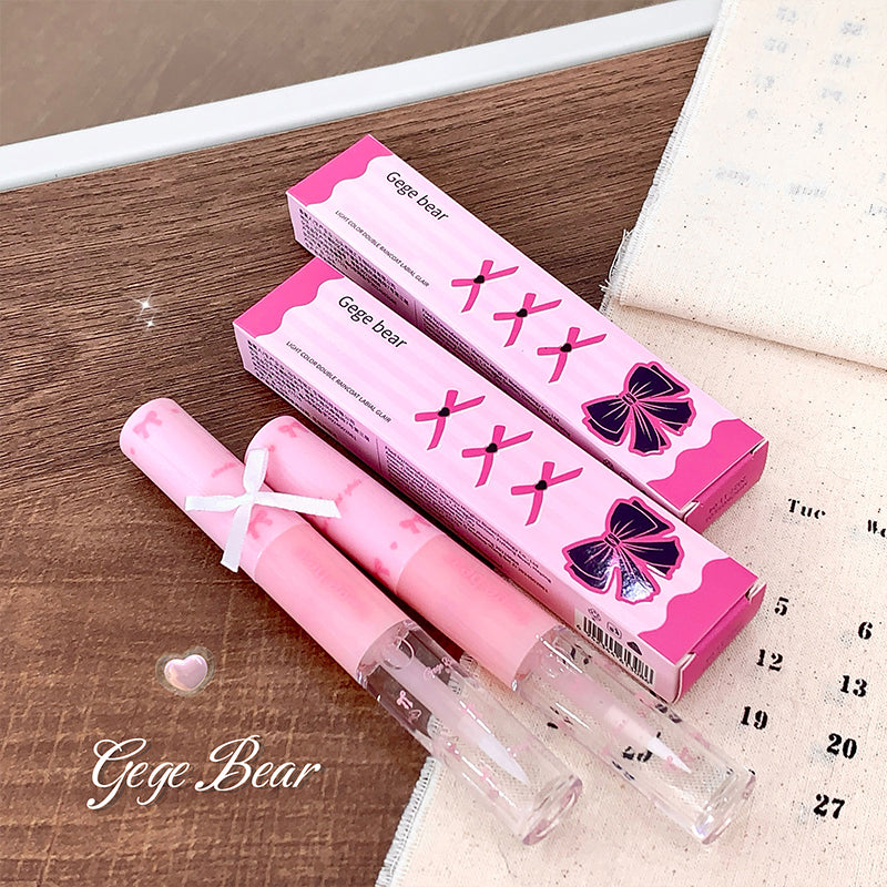 Pink lip gloss with packaging on a wooden surface