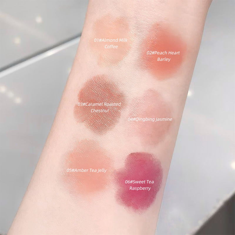 Swatches of different lip colors on a person's arm with color names and codes.