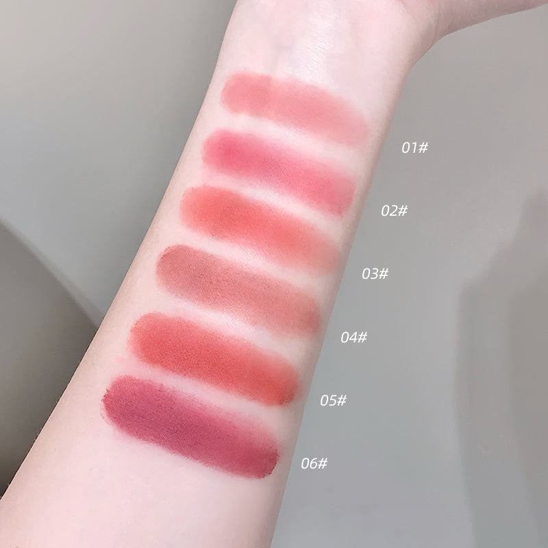 Lipstick swatches on a person's arm with color codes labeled.