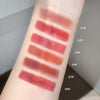 Lipstick swatches on a person's arm with color labels