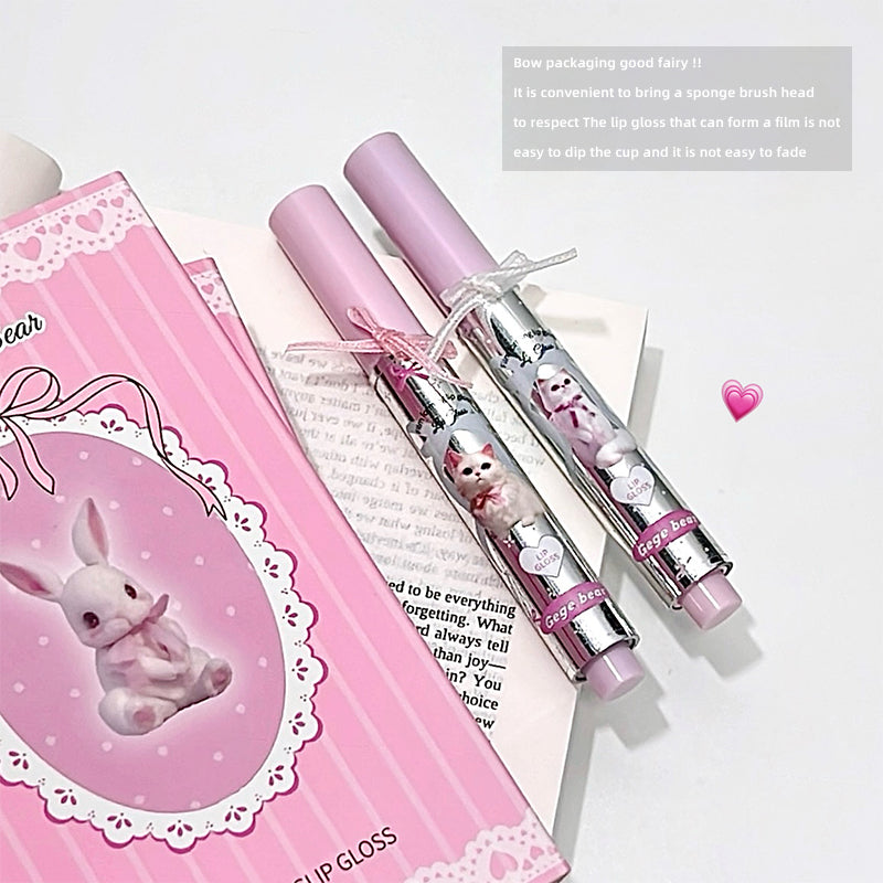 Pink lip gloss with packaging featuring a cartoon rabbit on a white background