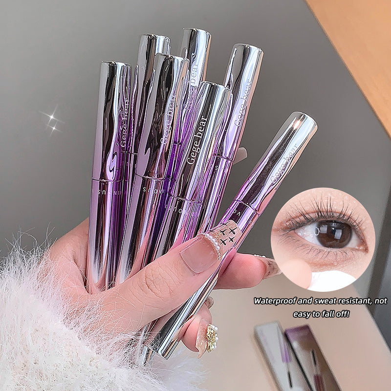 Hand holding multiple silver and purple eyelash extensions with close-up of an eye wearing the extensions.