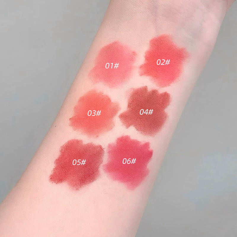 Lipstick swatches on a person's arm with color codes labeled.