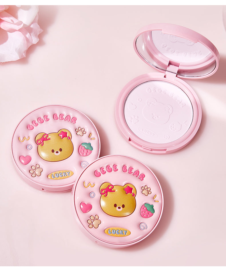 Compact powder with bear design on a pink background