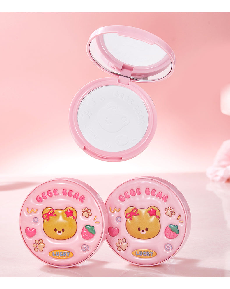 Compact powder with a mirror and two round containers on a pink background, featuring a bear design.