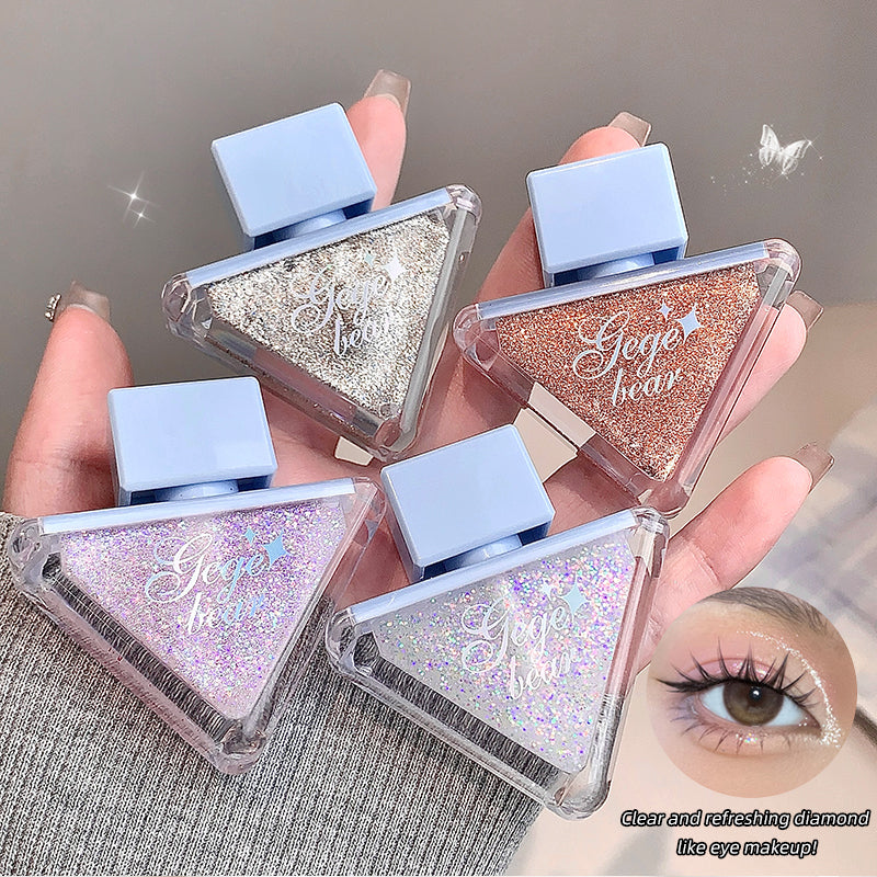 Four small cosmetic containers with glittery contents held by a hand, with a close-up of an eye in the corner.