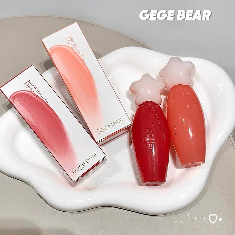 Two lip glosses and their packaging on a white dish with 'GEGE BEAR' branding.