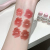 Lipstick swatches on a person's arm with labeled colors, next to lipsticks in small containers.