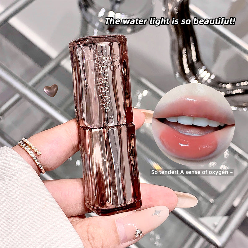 Lipstick held in a hand with a close-up of lips wearing the lipstick, set against a metallic background.