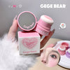 Pink makeup product with 'Gege Bear' branding held by a hand, with packaging and blurred face in the background.