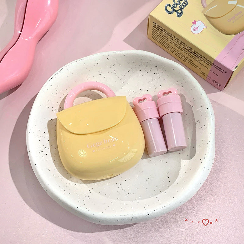 Yellow and pink cosmetic set on a white plate with a pink background
